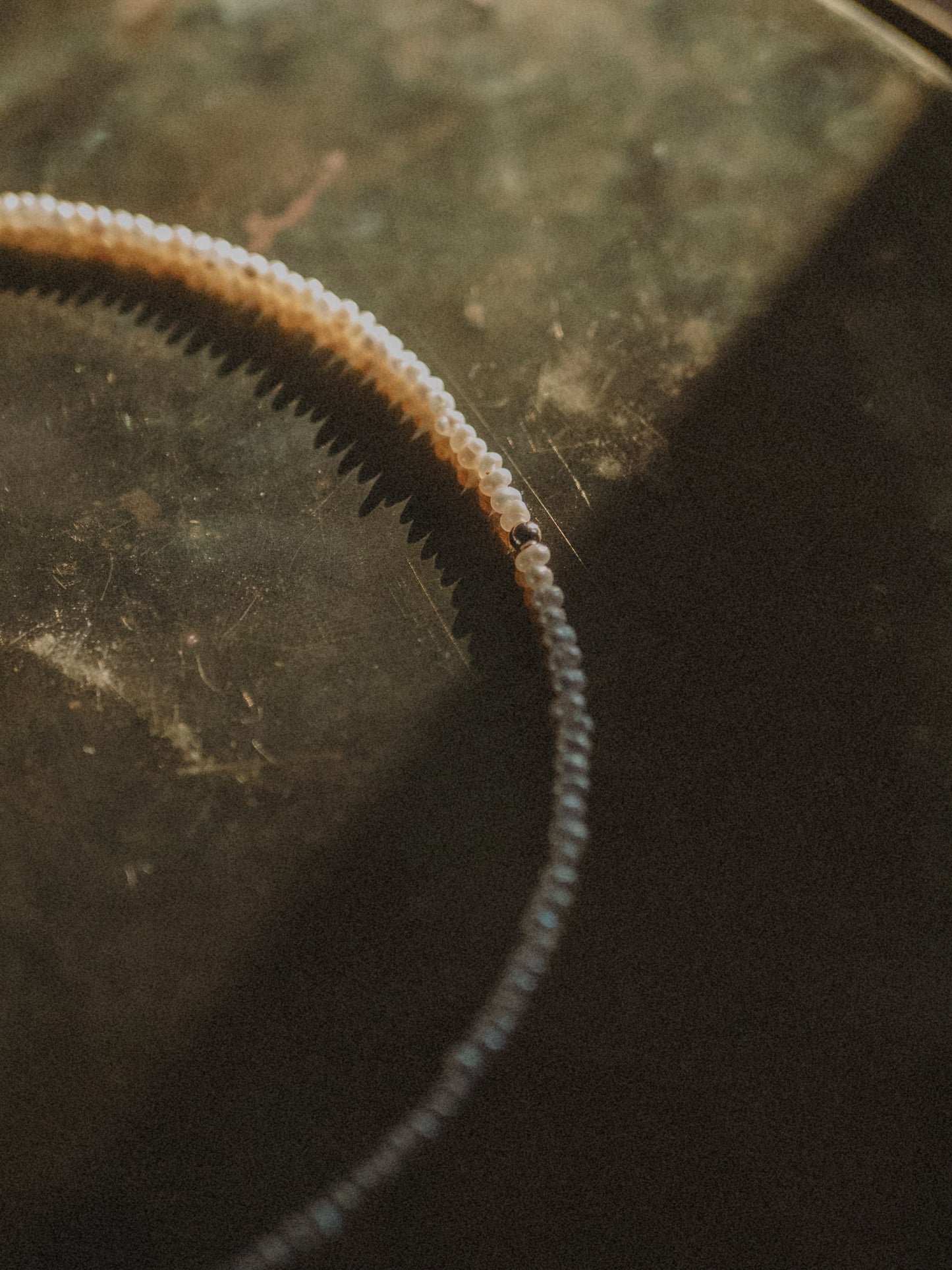 Close-up of a keshi choker neckalce on a textured surface